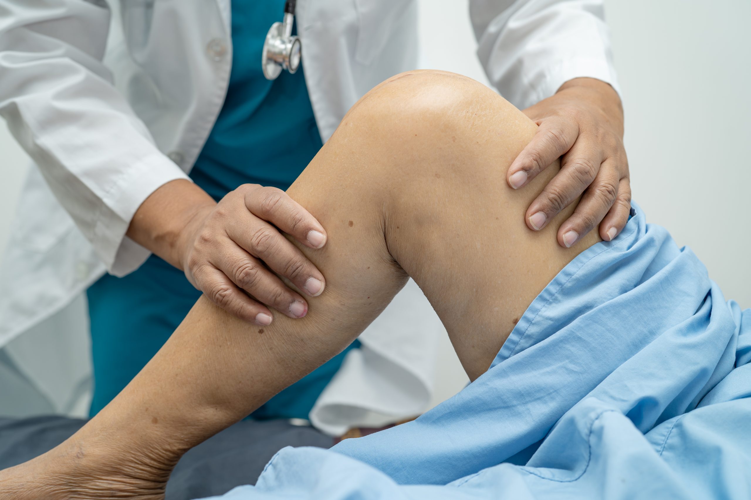 Asian doctor physiotherapist examining, massaging and treatment
